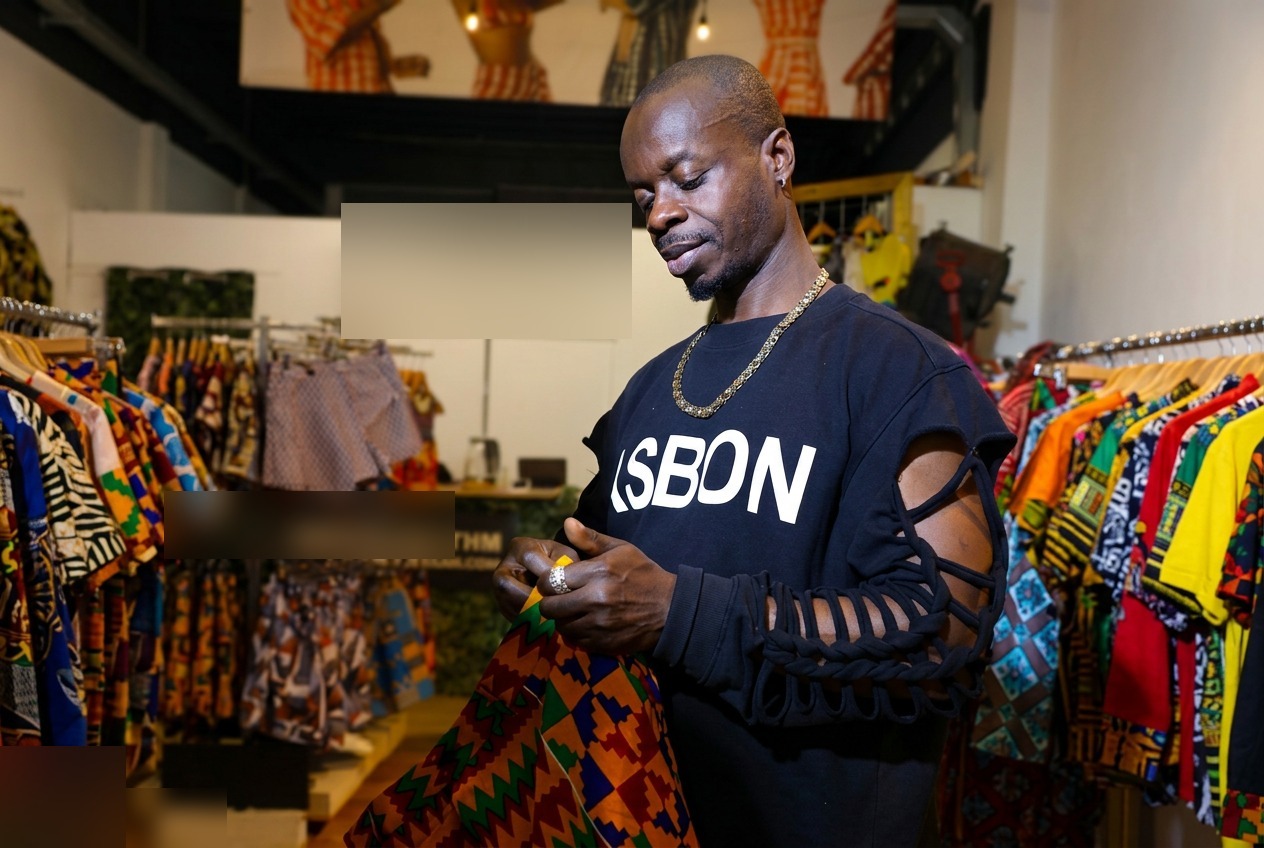 Osei Asibey Bonsu — founder of Asbon Fashion — selecting kente fabric